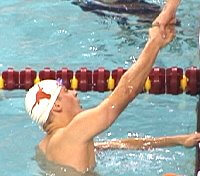 Texas anchor swimmer Bryan Jones is congratulated for the 400 Medley Relay victory