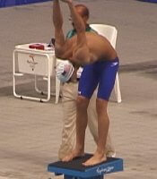 American hopeful in the 200 Fly, Michael Phelps, stretches on the blocks before his heat.
