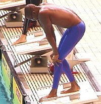 Sabir on the blocks before the 100 Free showing off his blue Speedo leg suit.