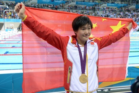 Jul 31, 2012; London, United Kingdom; Ye Shiwen (CHN) poses with her gold medal and a China flag after winning the women's 200m individual medley finals during the London 2012 Olympic Games at Aquatics Centre. Mandatory Credit: Kirby Lee-USA TODAY Sports