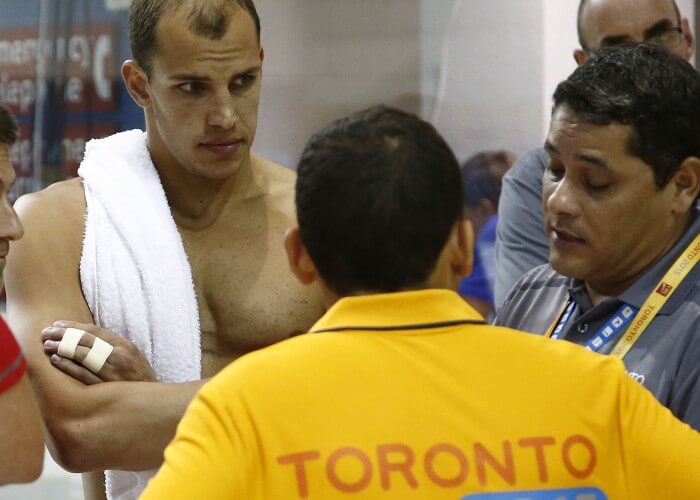 Jul 15, 2015; Toronto, Ontario, CAN; Michael Weiss of the the United States talks with officials after being disqualified form the men’s 4x200m freestyle relay final for having his fingers taped during the 2015 Pan Am Games at Pan Am Aquatics UTS Centre and Field House. Mandatory Credit: Rob Schumacher-USA TODAY Sports