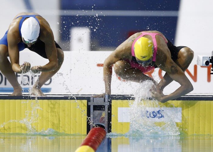 Jul 14, 2015; Toronto, Ontario, CAN; Jessica Camposano of Colombia (left) and Joanna Maranhao of Brazil splash water on themselves before the women's 200m butterfly swimming preliminaries during the 2015 Pan Am Games at Pan Am Aquatics UTS Centre and Field House. Mandatory Credit: Rob Schumacher-USA TODAY Sports