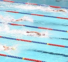 Tom Dolan (middle), Tom Wilkins (bottom), and Ron Karnaugh (top) are close together with 15m to go in the 200 IM.