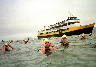 Masters swimmers  at the ALCATRAZ SHARKFEST swim sponsered by Envirosports.
 
This picture shows swimmers (unknown) as they jump off the boat and swim toward the starting line.