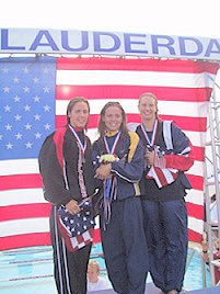 Natalie Coughlin accepts her award after breaking the American record in the 200m back (2:08.53).  On her left is Jamie Reid (second); on her right is Margaret Hoelzer (third). 2002 LCM Nationals
