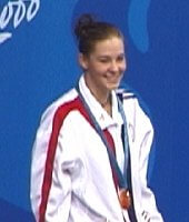Megan Quann of the USA receives her gold medal for victory in the 100 Breast.