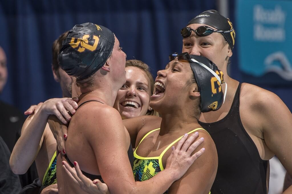Haley Anderson celebrates 500 free win with teammates.
