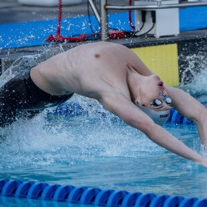 Ryan Harty wins the 100 backstroke.