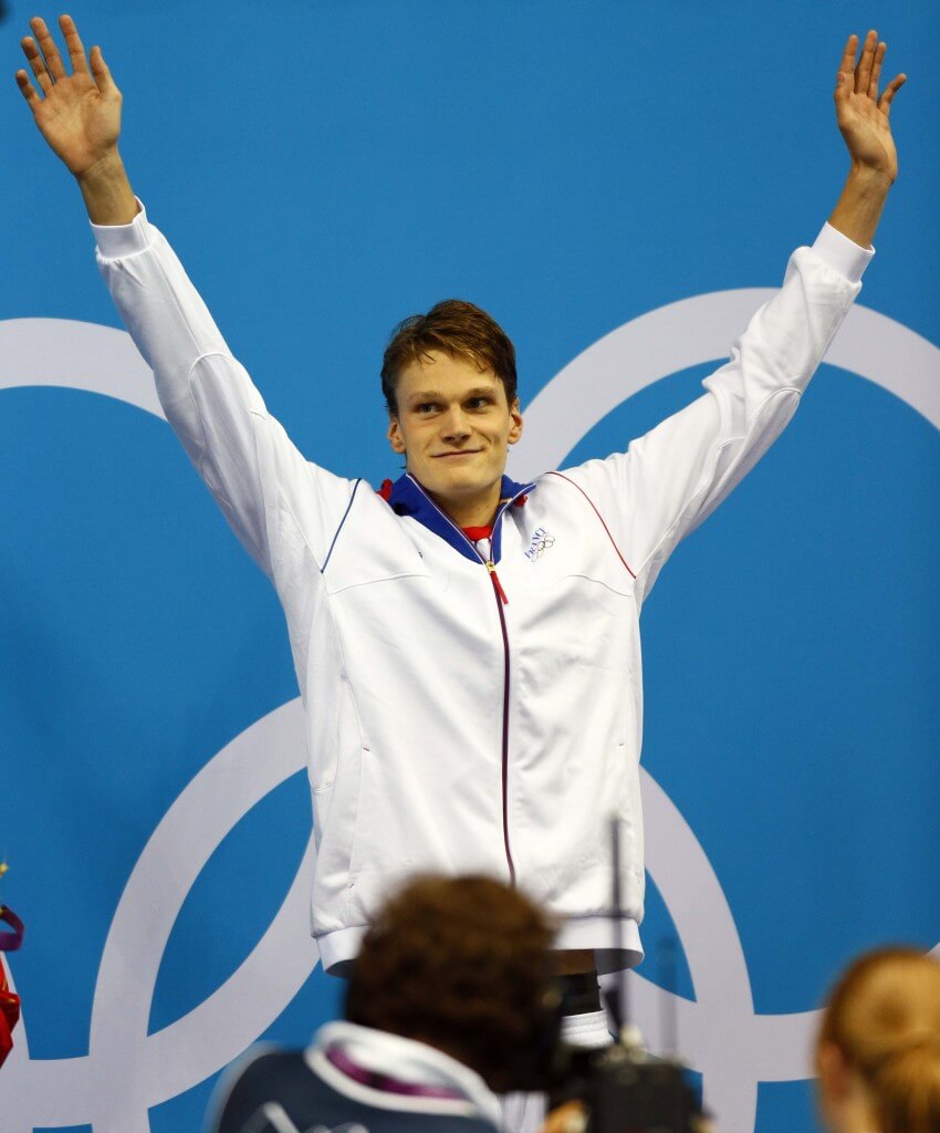 Jul 30, 2012; London, United Kingdom; Yannick Agnel (FRA) celebrates from the podium after winning the men's 200m freestyle finals during the London 2012 Olympic Games at Aquatics Centre. Mandatory Credit: Rob Schumacher-USA TODAY Sports