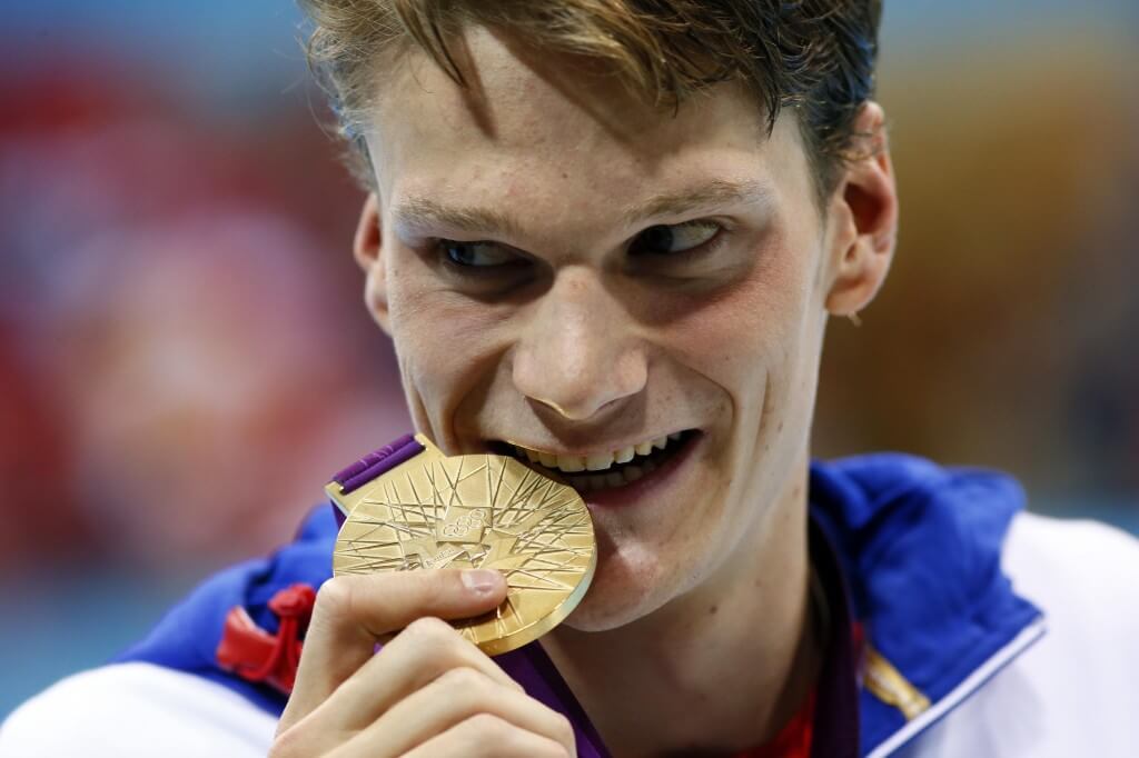 Jul 30, 2012; London, United Kingdom; Yannick Agnel (FRA) poses with his gold medal after winning the men's 200m freestyle finals during the London 2012 Olympic Games at Aquatics Centre. Mandatory Credit: Rob Schumacher-USA TODAY Sports