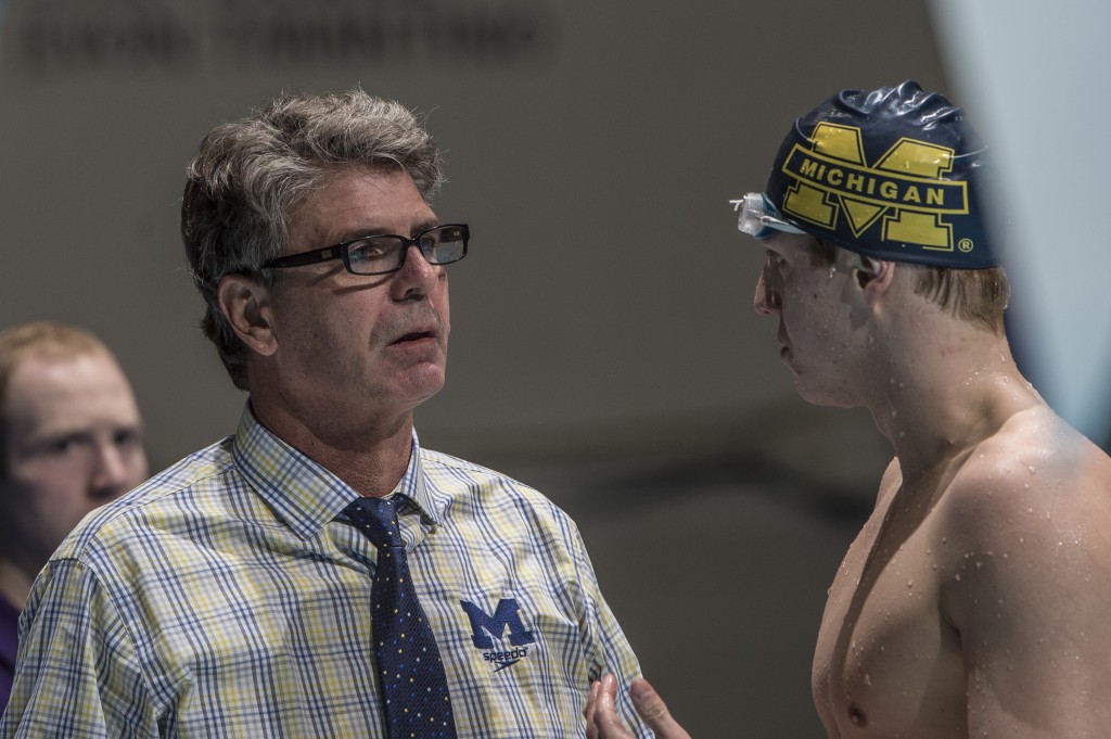 Mike Bottom coaching a swimmer before day 2 prelims.