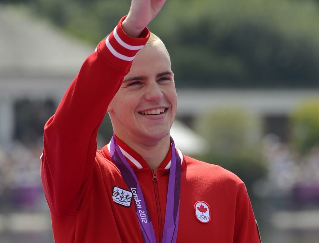 Aug 10, 2012; London, United Kingdom; Bronze medalist Richard Weinberger (CAN) waves to the crowd after receiving his medal in the men's open water 10km swim during the London 2012 Olympic Games at Hyde Park. Mandatory Credit: Andrew P. Scott-USA TODAY Sports