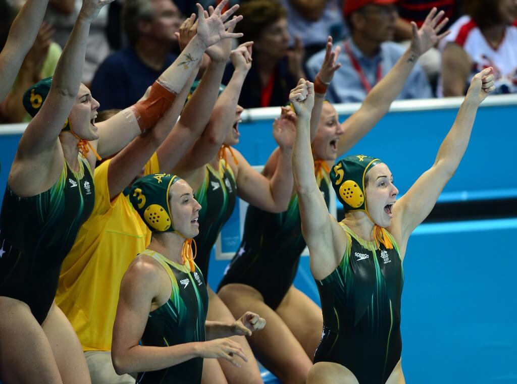 Aug 7, 2012; London, United Kingdom; Australia defender Jane Moran (5) celebrates on the bench with teammate after scoring a goal to send the game into over time against USA in the women's semifinal in the London 2012 Olympic Games at Water Polo Arena. Mandatory Credit: Andrew Weber-USA TODAY Sports