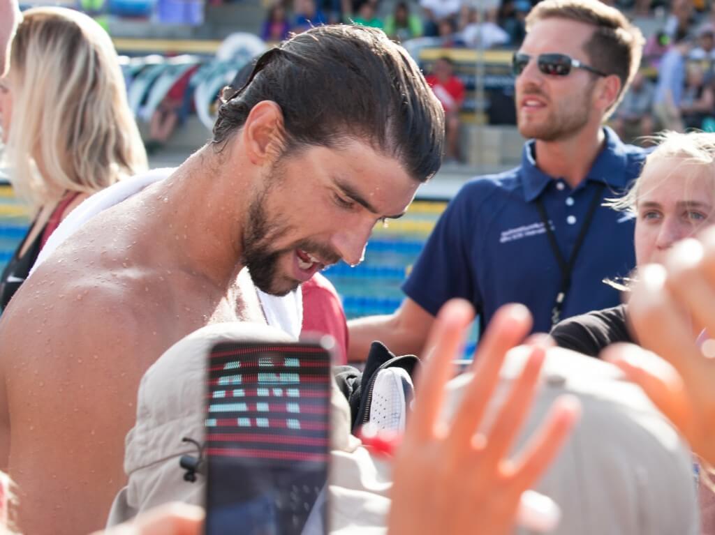 Michael Phelps signs autograph