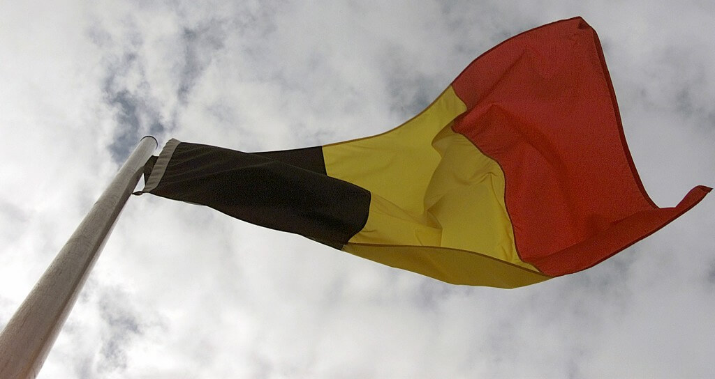 The Belgium flag, one of the many flags represented on the testing site area, waves in the wind during the exercise COMBINED ENDEAVOR (CE) 2000. CE 2000, currently hosted by Germany, is the largest information and communication systems exercise in the world. This exercise is the sixth in a series of multinational communication interoperability workshops where military personnel from 35 nations get together for 14 days to focus on Command, Control, Communications, and Computers (C4) interoperability testing and documentation and to meet and interact on a personal level.