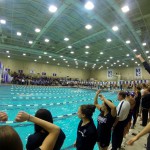 Northwestern team members anxiously watch their A- 400 free relay as they attack the pool record.