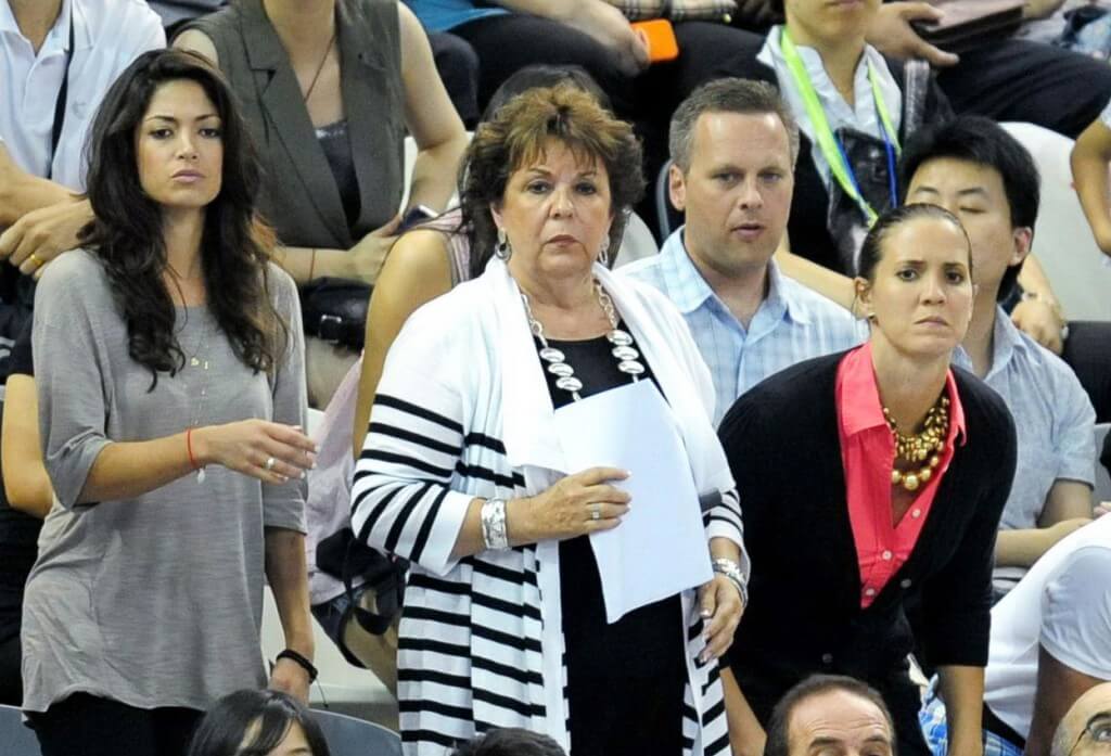 Nicole Johnson and Debbie Phelps cheer for Michael Phelps in 2011