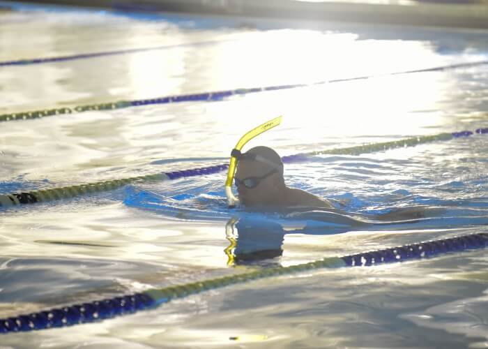 Lt. Shannon Scaff, an instructor at the Coast Guard Maritime Law Enforcement Academy in Charleston, South Carolina, takes a lap during a long distance swim he dedicated to a fallen Coast Guard aircrew, Feb. 27, 2015. Scaff undertook the challenge of swimming in a local Charleston pool for 24 hours to bring awareness and support to the families of fallen military members. (U.S. Coast Guard photo by Petty Officer 1st Class Stephen Lehmann)