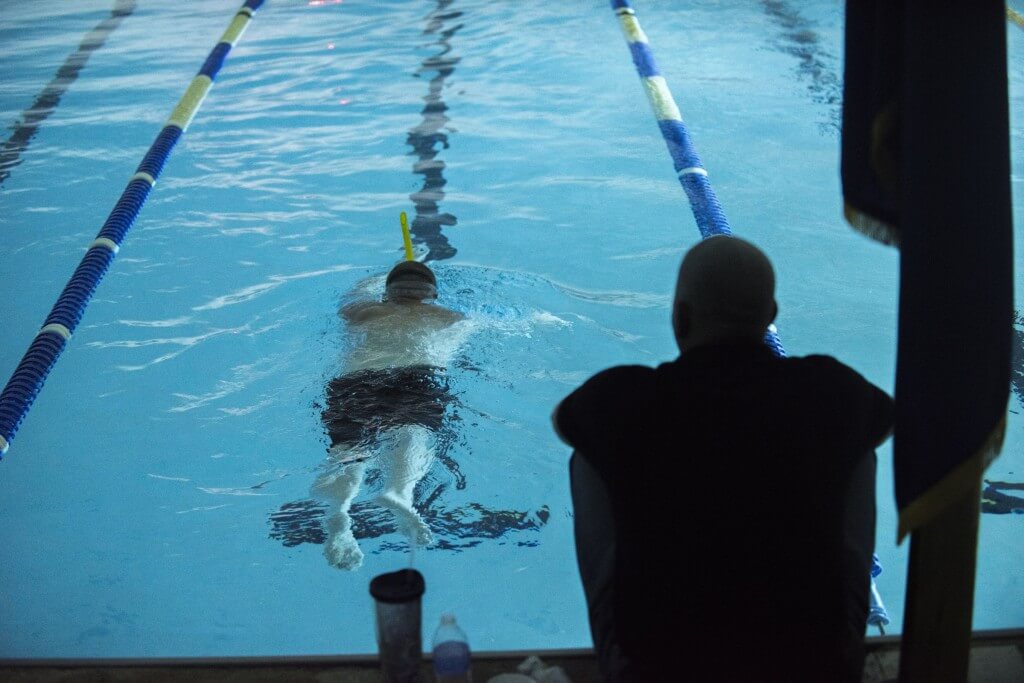 Lt. Shannon Scaff, an instructor at the Coast Guard Maritime Law Enforcement Academy in Charleston, S.C., takes a lap during a long distance swim he dedicated to a fallen Coast Guard aircrew, Feb. 27, 2015. Scaff undertook the challenge of swimming in a local Charleston pool for 24 hours to bring awareness and support to the families of fallen military members. (U.S. Coast Guard photo by Petty Officer 1st Class Stephen Lehmann)