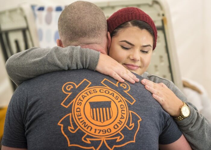 Madison Scaff hugs her father, Lt. Shannon Scaff, after he finished his goal of swimming 24 hours in a pool to memorialize the fallen aircrew of Coast Guard helicopter 6535 in Charleston, S.C., Feb. 28, 2015. Scaff trained for over a year to help prepare him for this test of endurance and will. U.S. Coast Guard photo by Petty Officer 1st Class Stephen Lehmann.