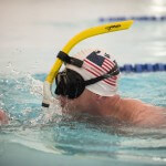 Lt. Shannon Scaff, an instructor at the Coast Guard Maritime Law Enforcement Academy in Charleston, S.C., finishes a lap during a long distance swim he dedicated to a fallen Coast Guard aircrew, Feb. 27, 2015. Scaff undertook the challenge of swimming in a local Charleston pool for 24 hours to bring awareness and support to the families of fallen military members. (U.S. Coast Guard photo by Petty Officer 1st Class Stephen Lehmann)