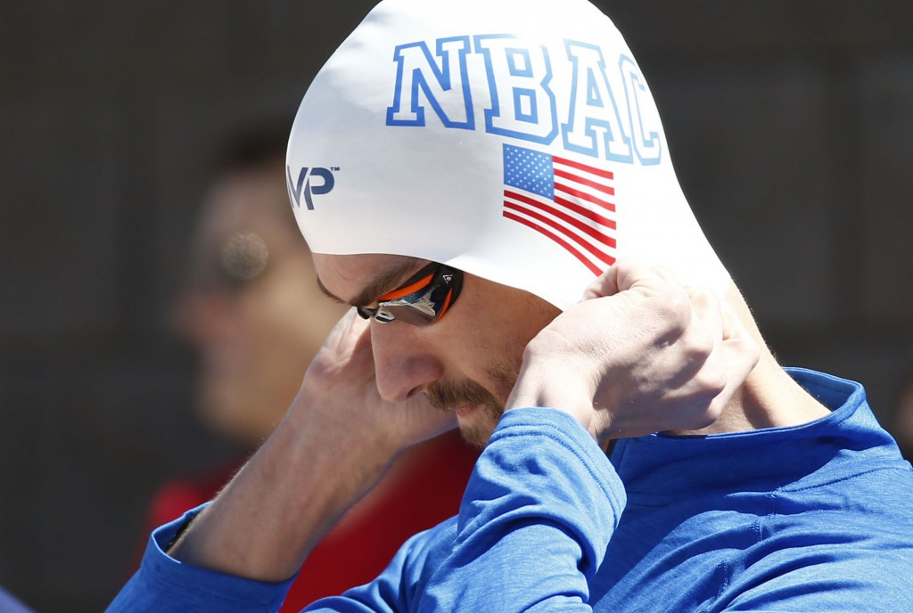 Apr 16, 2015; Mesa, AZ, USA; Michael Phelps pulls down his cap before swimming in the Men's 100 meter butterfly prelims during the 2015 Arena Pro Swim Series at the Skyline Aquatic Center. Mandatory Credit: Rob Schumacher/Arizona Republic via USA TODAY Sports
