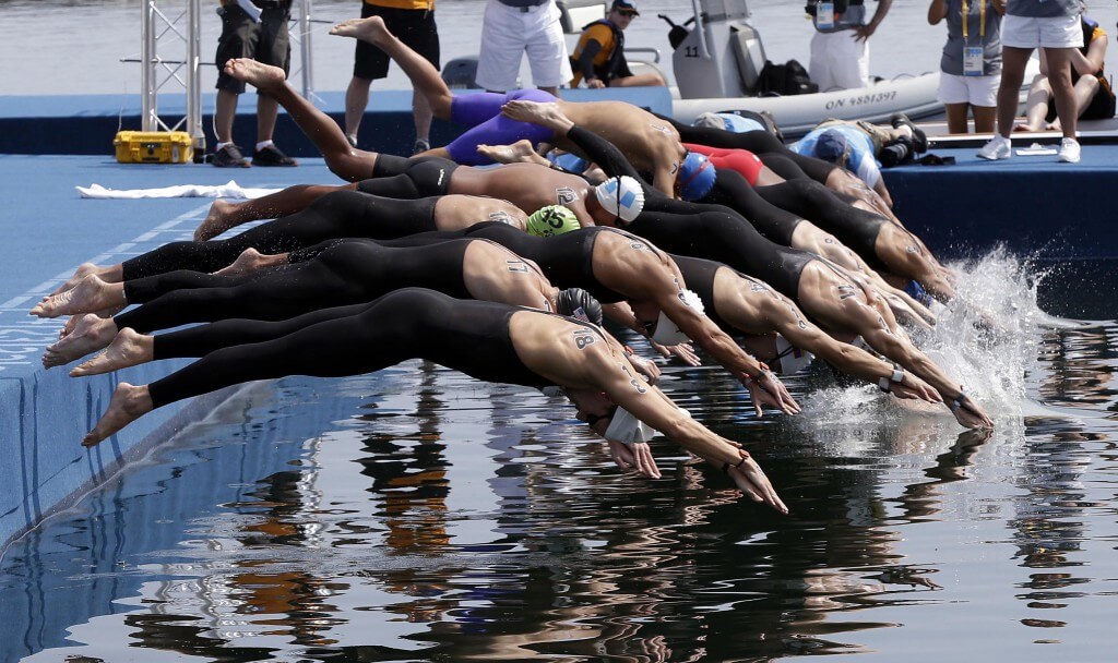 Jul 12, 2015; Toronto, Ontario, CAN; Competitors dive in the water at the start of the men's open water swim during the 2015 Pan Am Games at Ontario Place West Channel. Mandatory Credit: Erich Schlegel-USA TODAY Sports