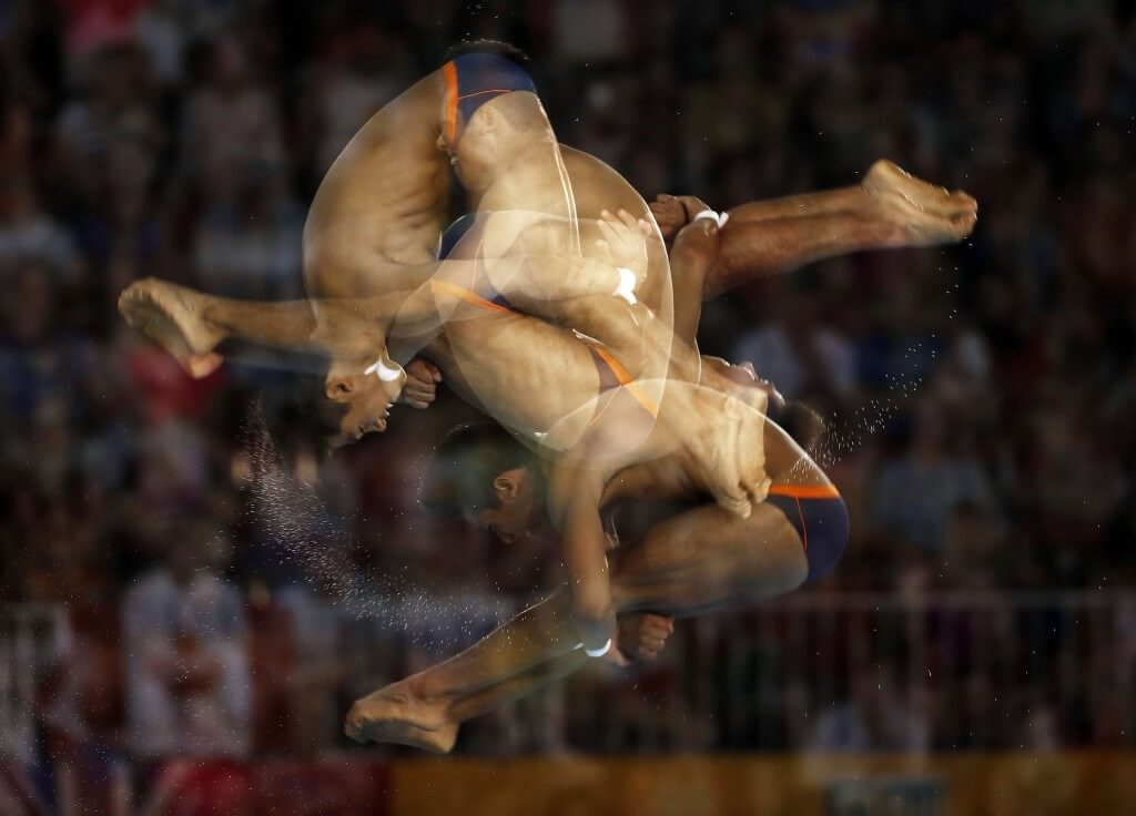 Jul 13, 2015; Toronto, Ontario, USA; (editors note: multiple exposure function used in the creation of this image) Jonathan Ruvalcaba of Mexico competes in the men's 10m platform during the 2015 Pan Am Games at Pan Am Aquatics UTS Centre and Field House. Mandatory Credit: Rob Schumacher-USA TODAY Sports