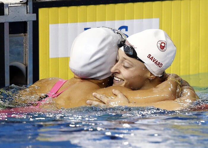 Jul 15, 2015; Toronto, Ontario, CAN; Katerine Savard of Canada hugs Larissa Martins of Brazil after competing in the xxxxxx preliminary heat during the 2015 Pan women's 200m freestyle Games at Pan Am Aquatics UTS Centre and Field House. Mandatory Credit: Rob Schumacher-USA TODAY Sports