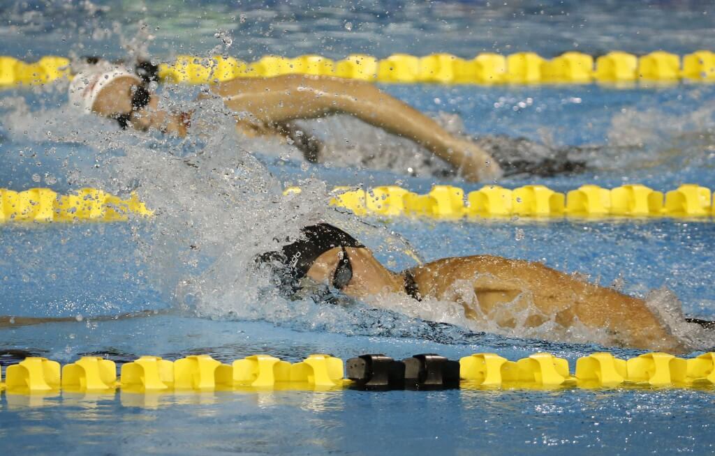 Jul 16, 2015; Toronto, Ontario, CAN; Caitlin Leverenz of the United States (bottom) races Emily Overholt of Canada (top) in the women's swimming 400m individual medley final during the 2015 Pan Am Games at Pan Am Aquatics UTS Centre and Field House. Mandatory Credit: Rob Schumacher-USA TODAY Sports
