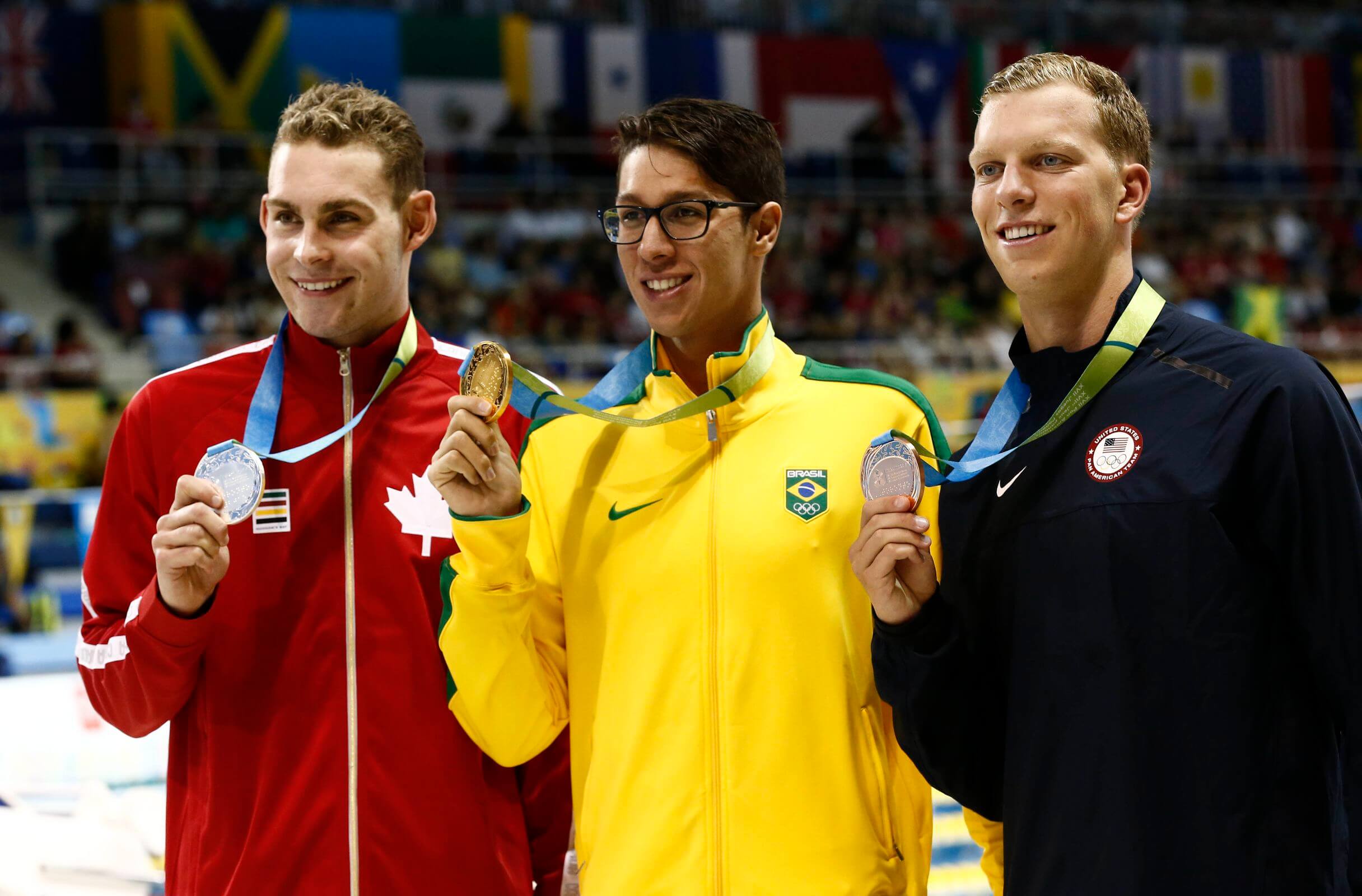Jul 17, 2015; Toronto, Ontario, CAN; Luke Reilly of Canada (left) , Brandonn Almeida of Brazil (middle) and Max Williamson of the United States (right) pose with their medals after the men's swimming 400m individual medley final the 2015 Pan Am Games at Pan Am Aquatics UTS Centre and Field House. Mandatory Credit: Rob Schumacher-USA TODAY Sports
