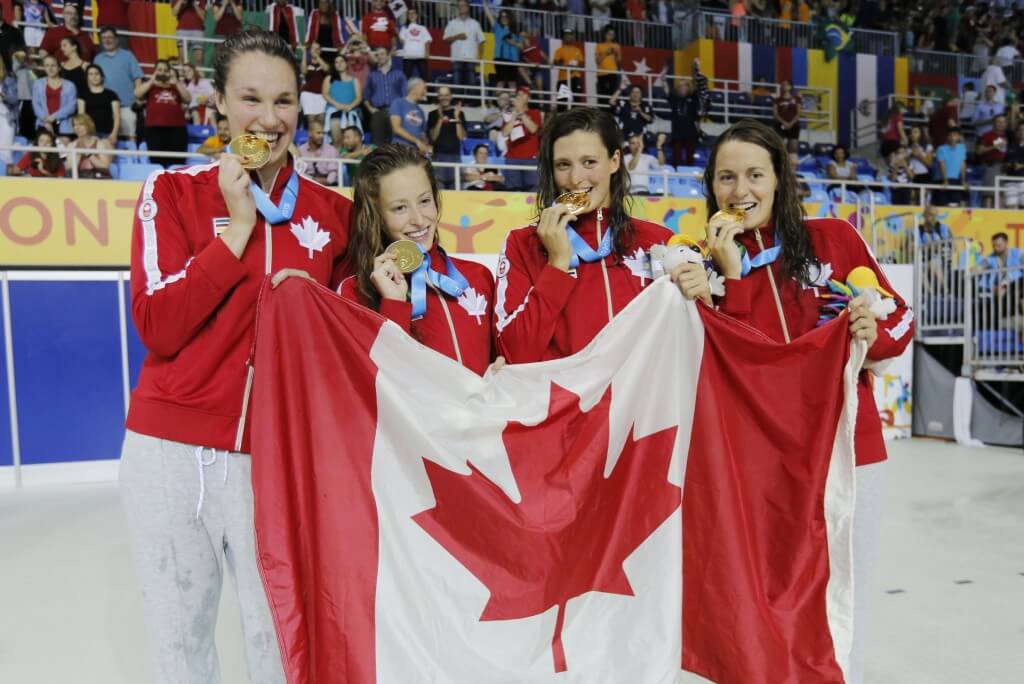 Jul 14, 2015; Toronto, Ontario, CAN; Canada team members Sandrine Mainville , Katerine Savard , Michelle Williams and Chantal Van Landeghem of Canada celebrate after winning the women's 4x100m freestyle swimming relay final during the 2015 Pan Am Games at Pan Am Aquatics UTS Centre and Field House. Mandatory Credit: Erich Schlegel-USA TODAY Sports
