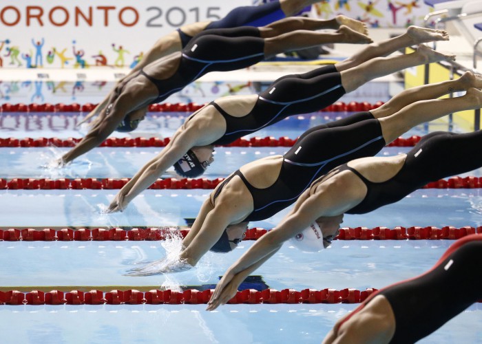 Jul 18, 2015; Toronto, Ontario, CAN; Caitlin Leverenz of the United States dives into the pool at the start of the women's swimming 200m individual medley final during the 2015 Pan Am Games at Pan Am Aquatics UTS Centre and Field House. Mandatory Credit: Rob Schumacher-USA TODAY Sports