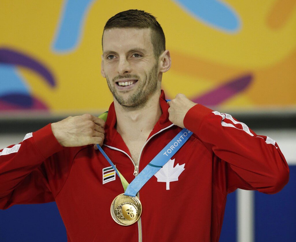 Jul 17, 2015; Toronto, Ontario, CAN; Ryan Cochrane of Canada adjusts his gold medal as he stands on the podium after the men's 400m freestyle final the 2015 Pan Am Games at Pan Am Aquatics UTS Centre and Field House. Mandatory Credit: Erich Schlegel-USA TODAY Sports