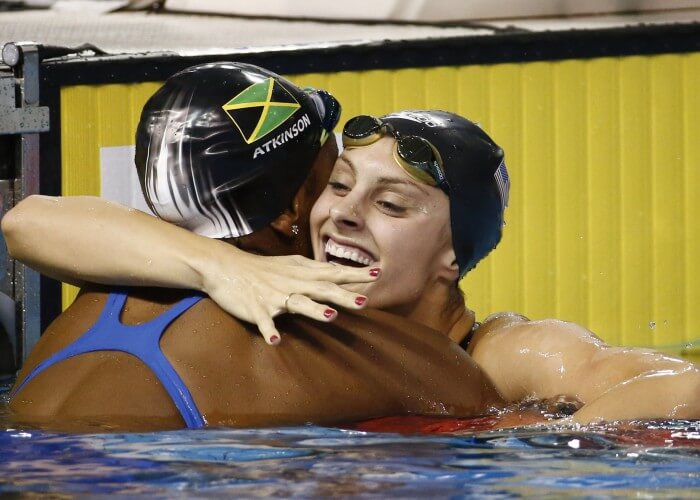 Jul 17, 2015; Toronto, Ontario, CAN; Katie Meili of the United States (right) gets a hug from Alia Atkinson of Jamaica (left) after the women's 100m breaststroke final the 2015 Pan Am Games at Pan Am Aquatics UTS Centre and Field House. Mandatory Credit: Rob Schumacher-USA TODAY Sports