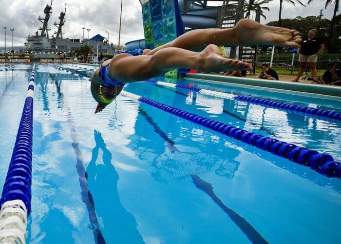 120706-F-MQ656-228 JOINT BASE PEARL HARBOR-HICKAM (July 6, 2012) Sailors from the Royal New Zealand navy and U.S. Navy dive into the pool to start a 200-meter freestyle relay during a Rim of the Pacific Exercise (RIMPAC) international swim meet. Over one hundred Sailors from multiple nations gathered at Scott Pool to compete in a friendly swim meet and get to know each other prior to the start of the operational portion of RIMPAC 2012. Twenty-two nations, more than 40 ships and submarines, more than 200 aircraft and 25,000 personnel are participating in RIMPAC exercise from Jun. 29 to Aug. 3, in and around the Hawaiian Islands. The world's largest international maritime exercise, RIMPAC provides a unique training opportunity that helps participants foster and sustain the cooperative relationships that are critical to ensuring the safety of sea lanes and security on the worlds oceans. RIMPAC 2012 is the 23rd exercise in the series that began in 1971. (Department of Defense photo by U.S. Air Force Tech. Sgt. Michael R. Holzworth/Released)
