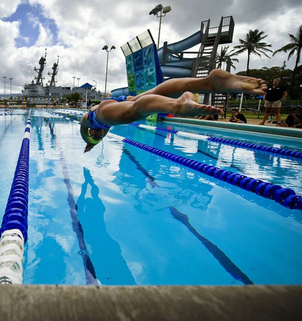 120706-F-MQ656-228 JOINT BASE PEARL HARBOR-HICKAM (July 6, 2012) Sailors from the Royal New Zealand navy and U.S. Navy dive into the pool to start a 200-meter freestyle relay during a Rim of the Pacific Exercise (RIMPAC) international swim meet. Over one hundred Sailors from multiple nations gathered at Scott Pool to compete in a friendly swim meet and get to know each other prior to the start of the operational portion of RIMPAC 2012. Twenty-two nations, more than 40 ships and submarines, more than 200 aircraft and 25,000 personnel are participating in RIMPAC exercise from Jun. 29 to Aug. 3, in and around the Hawaiian Islands. The world's largest international maritime exercise, RIMPAC provides a unique training opportunity that helps participants foster and sustain the cooperative relationships that are critical to ensuring the safety of sea lanes and security on the worlds oceans. RIMPAC 2012 is the 23rd exercise in the series that began in 1971. (Department of Defense photo by U.S. Air Force Tech. Sgt. Michael R. Holzworth/Released)