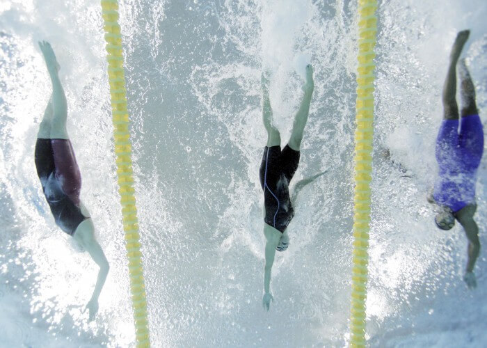 Jul 14, 2015; Toronto, Ontario, CAN; Chantal Van Landeghem of Canada (left) finishes ahead of Natalie Coughlin of the United States (middle) and Arianna Vanderpool-Wallace of the Bahamas (right) in the women's 100m freestyle swimming final during the 2015 Pan Am Games at Pan Am Aquatics UTS Centre and Field House. Mandatory Credit: Erich Schlegel-USA TODAY Sports