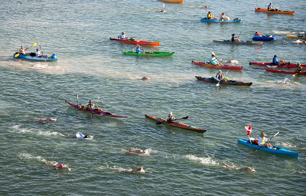 In this photo provided by the Florida Keys News Bureau, a portion of the field of about 200 registered entrants begins the Swim for Alligator Lighthouse open water contest Saturday, Sept. 19, 2015, off Islamorada, Fla. The 9-mile challenge on the Atlantic Ocean side of the Florida Keys island chain is being staged to create awareness of the need to preserve six aging lighthouses off the Keys that no longer serve as primary navigation aids for maritime traffic. FOR EDITORIAL USE ONLY (Andy Newman/Florida Keys News Bureau/HO)