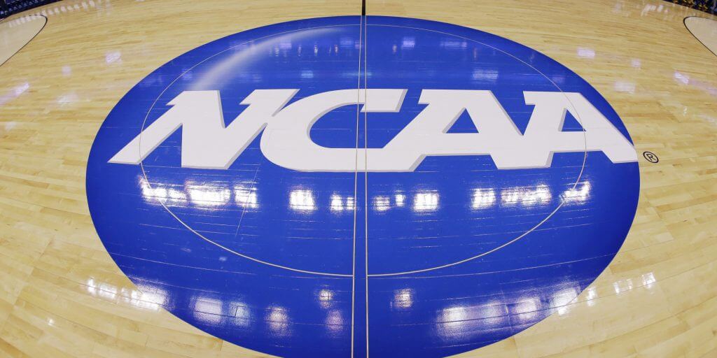 FILE - In this March 21, 2013, file photo, in this image taken with a fisheye lens, the NCAA logo is displayed at mid-court before Albany's practice for a second-round game of the NCAA college basketball tournament in Philadelphia. Barely a month ago, the NCAA was shamed into apologizing for trying to rig its own investigation into funny business at the University of Miami. According to a new report, that apology didn't go nearly far enough. (AP Photo/Matt Slocum, File)