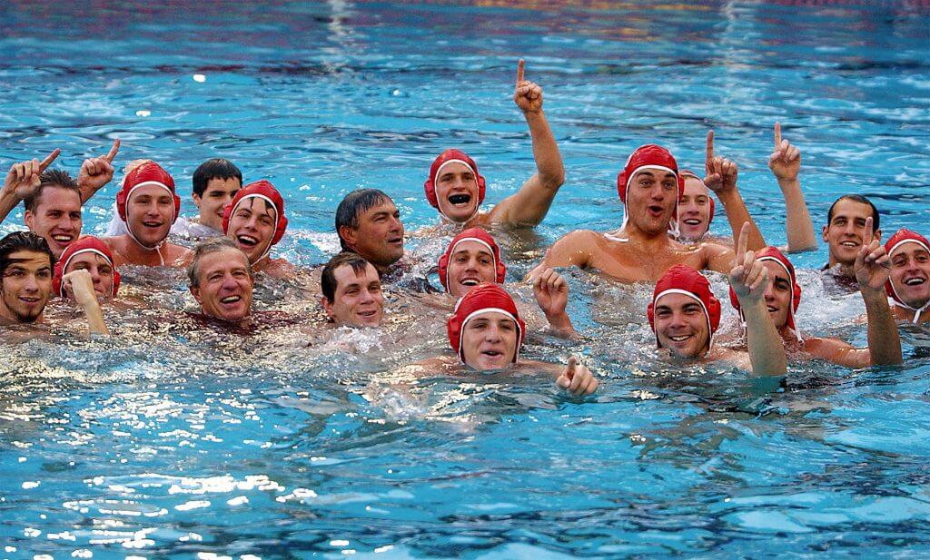 STANFORD, CA - DECEMBER 2: Brian Darrow, Jeff Guyman, Matt Moser, Todd Snider, head coach Dante Dettamanti, Mike Derse, Nick Ellis, assistant coach Ben Quittner, Tony Azevedo, Onno Koelman, Reed Gallogly, Mark Amott, Peter Hudnut, Jeff Nesmith, Pasi Dutton, Wolf Wigo, and Nathan Alldredge of the Stanford Cardinal after Stanford's 8-5 win over the UCLA Bruins for the NCAA water polo championship on December 12, 2001 at Deguerre Pool in Stanford, California.