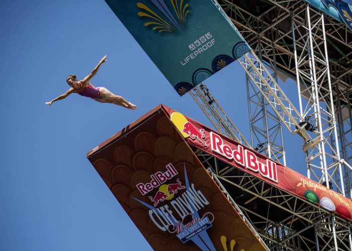 Ginger Huber of the USA dives from the 21 metre platform during the third stop of the Red Bull Cliff Diving World Series at Polignano a Mare, Italy on 23 July 2017. // Dean Treml/Red Bull Content Pool // P-20170723-01480 // Usage for editorial use only // Please go to www.redbullcontentpool.com for further information. //