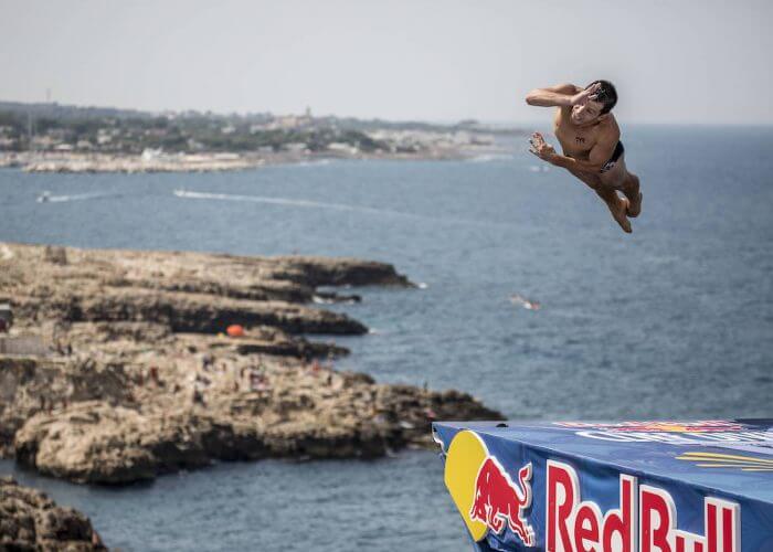 Steven LoBue of the USA dives from the 27 metre platform during the first competition day of the third stop of the Red Bull Cliff Diving World Series at Polignano a Mare, Italy on July 22 2017. // Dean Treml/Red Bull Content Pool // P-20170722-01013 // Usage for editorial use only // Please go to www.redbullcontentpool.com for further information. //