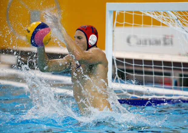 United States goalkeeper McQuin Baron blocks a shot by Ecuador during a water polo match at the Pan Am Games in Markham, Ontario, Tuesday, July 7, 2015. (AP Photo/Julio Cortez)