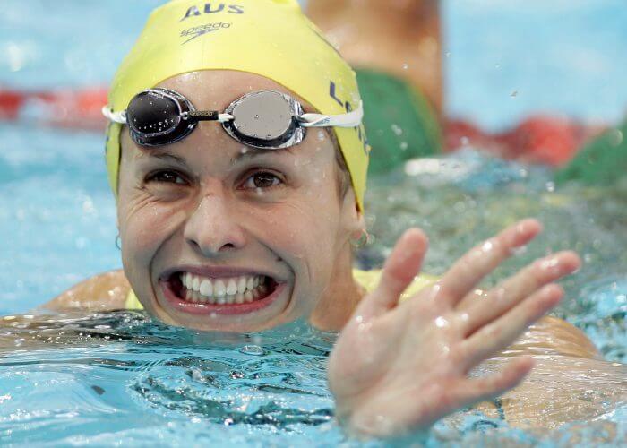 Libby Lenton Trickett smiles after competing in the heats of the women's 100m freestyle at the Commonwealth Games in Melbourne March 17, 2006. REUTERS/Tim Wimborne - GM1DSEGRRAAA