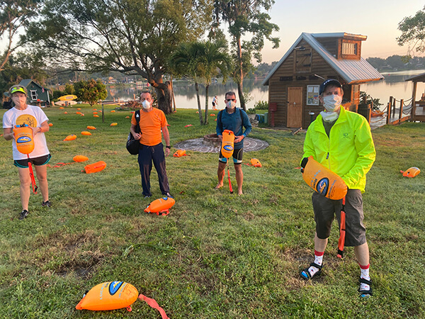 4 Volunteers spread out buoys before the swim