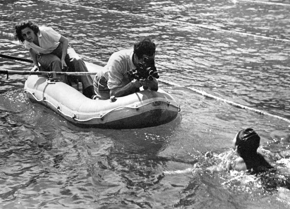 Swimming World January 2021 - Who Shot The Swimmers - The History of Swimming Through The Eyes of Photojournalists - Reifenstahl and Ertl filming in life raft