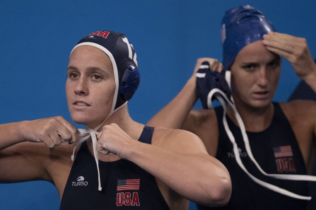 July 24, 2021; Tokyo, Japan; Team United States centre back Alys Williams (12) ties her cap before the match in the preliminary round Group B against Japan during the Tokyo 2020 Olympic Summer Games at Tatsumi Water Polo Centre. Mandatory Credit: Kyle Terada-USA TODAY Network