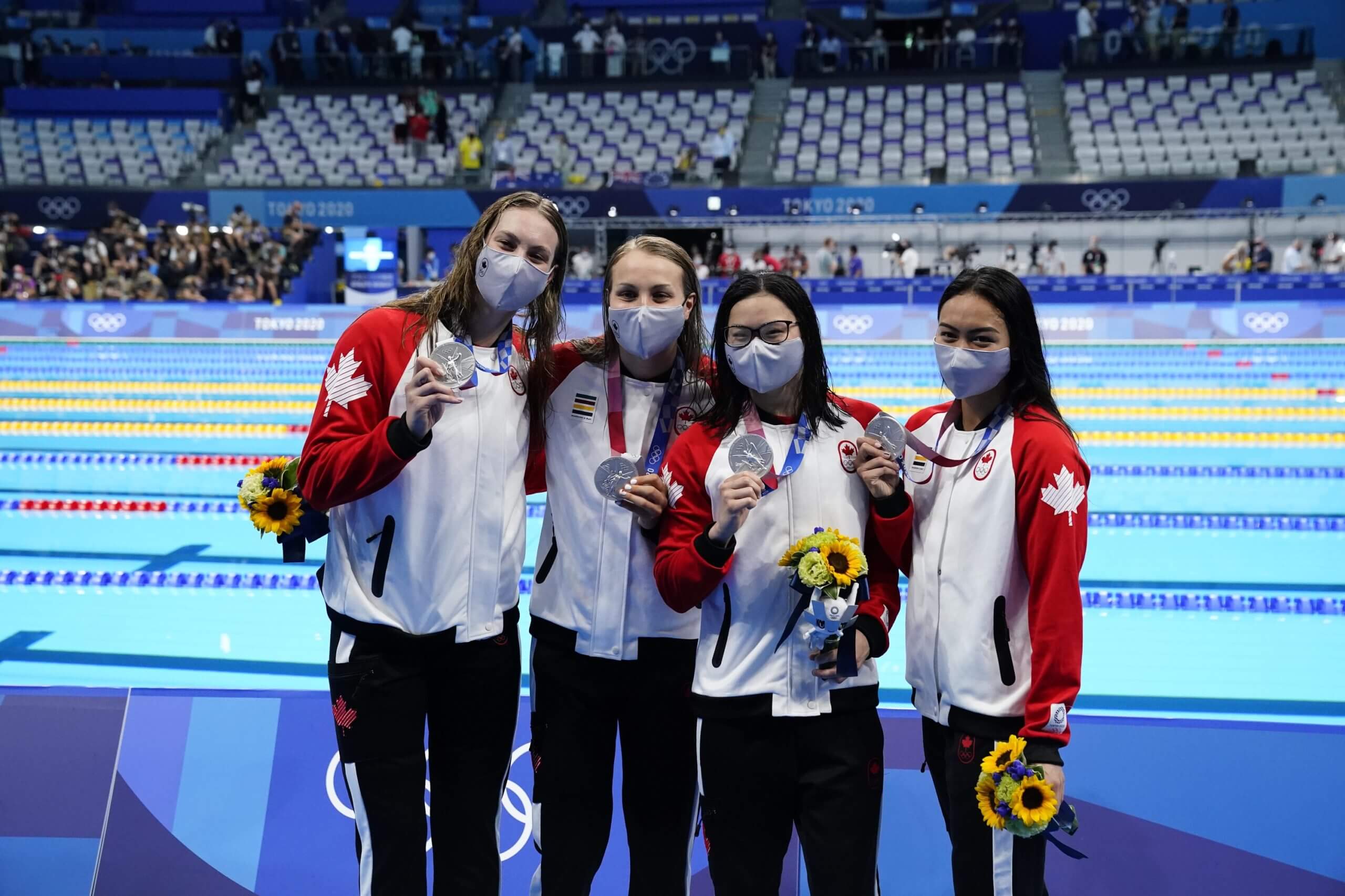 Jul 25, 2021; Tokyo, Japan; Canada team members Kayla Sanchez, Margaret Macneil, Rebecca Smith and Penny Oleksiak with their silver medals during the medals ceremony for the women's 4x100m freestyle relay during the Tokyo 2020 Olympic Summer Games at Tokyo Aquatics Centre. Mandatory Credit: Rob Schumacher-USA TODAY Network