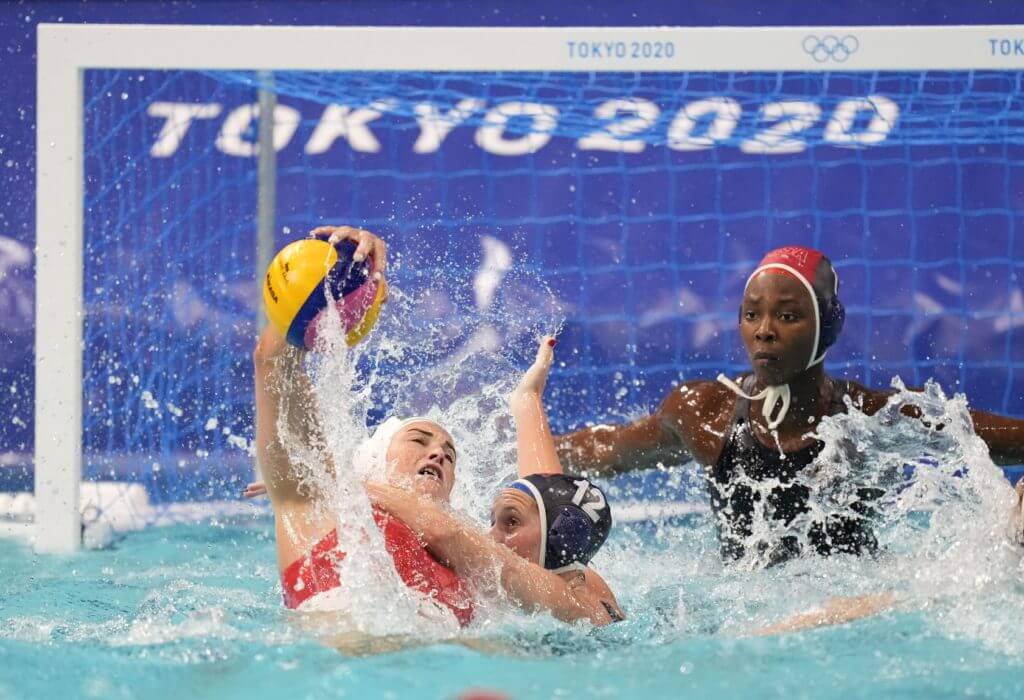 Jul 28, 2021; Tokyo, Japan; Hungary player Rebecca Parkes (6) is defended by USA player Alys Williams (12) in a group B match during the Tokyo 2020 Olympic Summer Games at Tatsumi Water Polo Centre. Mandatory Credit: James Lang-USA TODAY Sports
